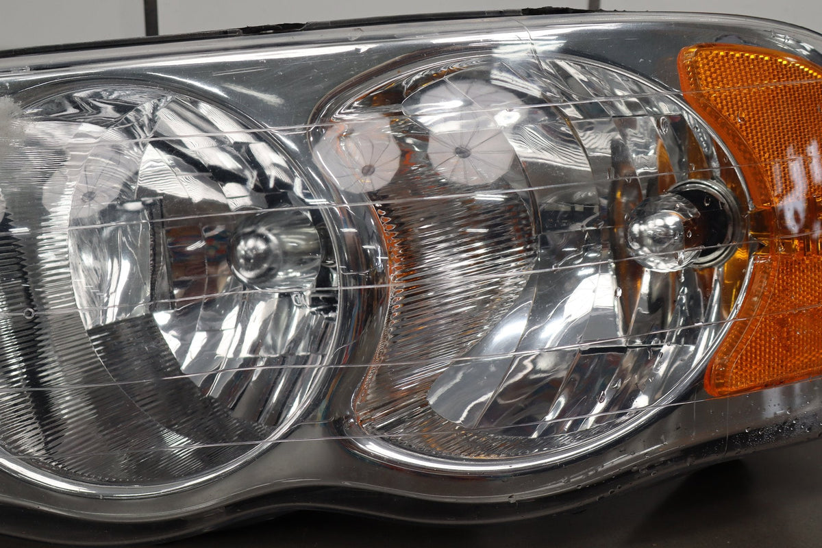 02-05 Dodge Ram LH Headlight OEM 55077121AG