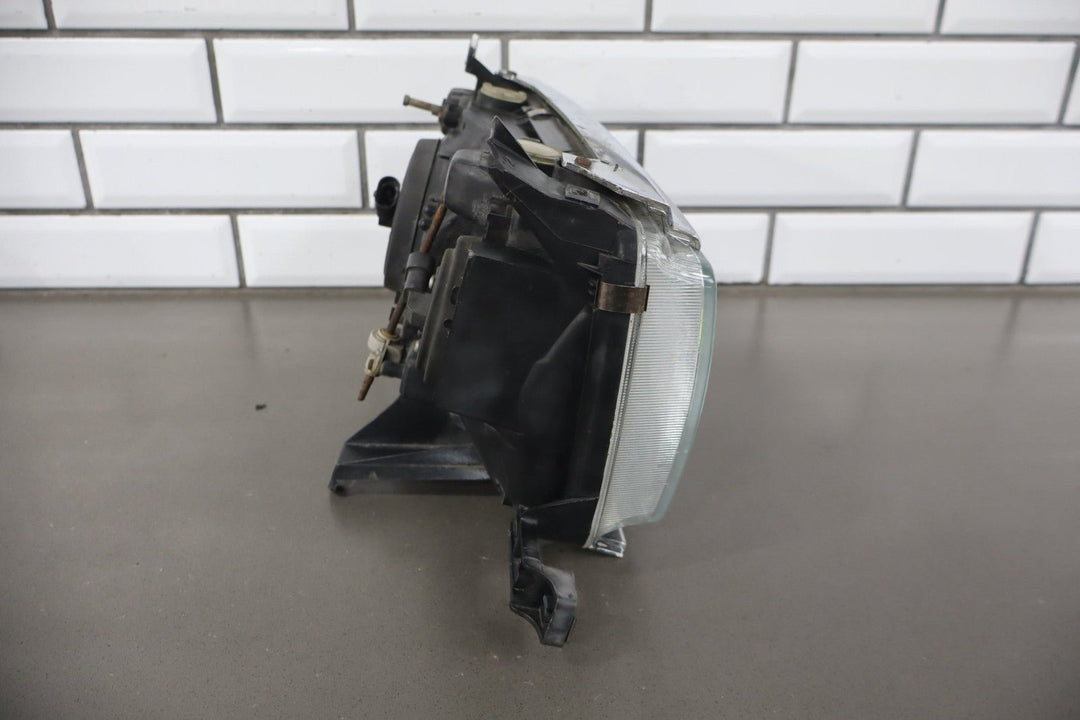 1995 - 1998 Toyota Land Cruiser Left Headlamp W/Chrome Trim 8111060395