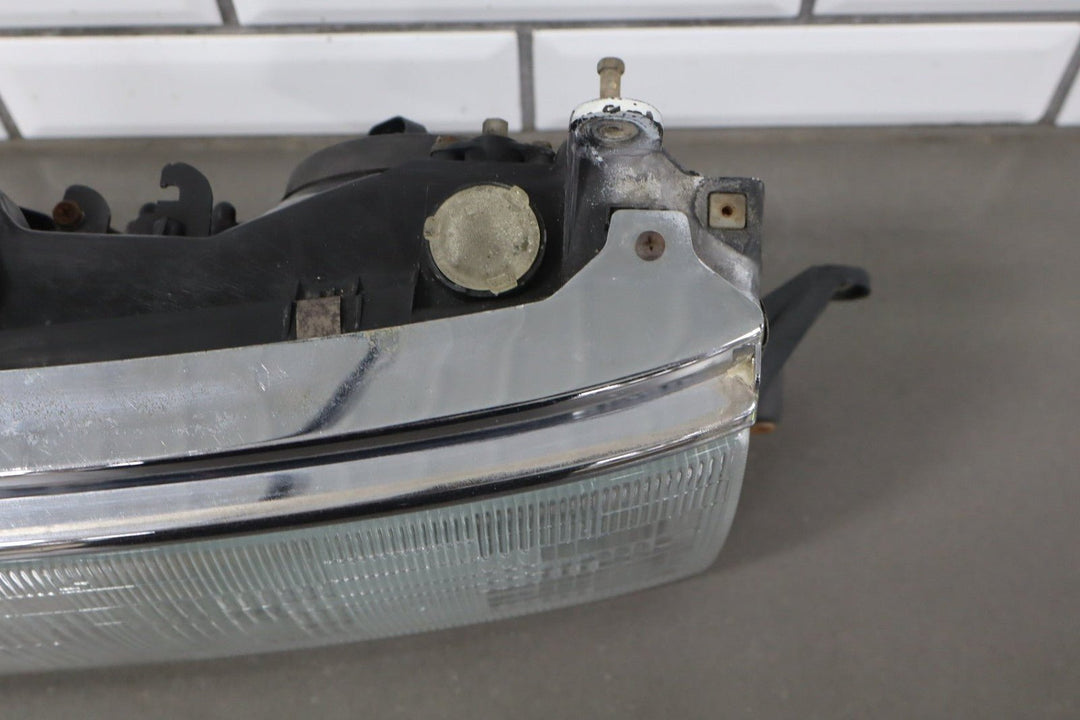 1995 - 1998 Toyota Land Cruiser Left Headlamp W/Chrome Trim 8111060395
