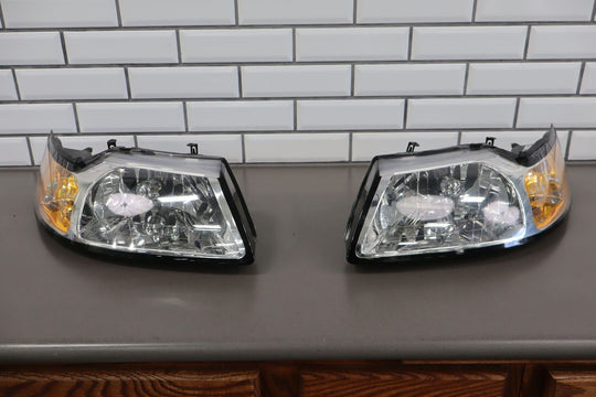 99-04 Ford Mustang TYC Aftermarket Headlight Pair (Left / Right) Clean Lenses