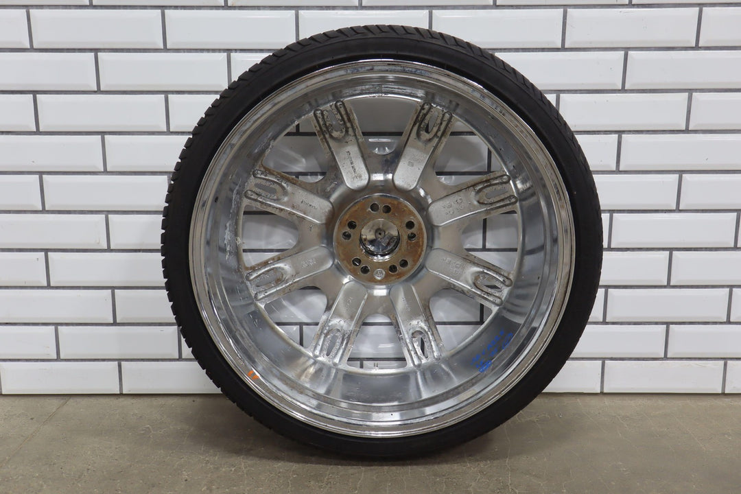 Chrome car wheel on a white brick wall background