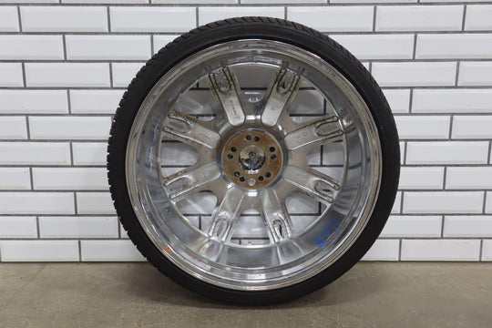 Chrome car wheel on a white brick wall background