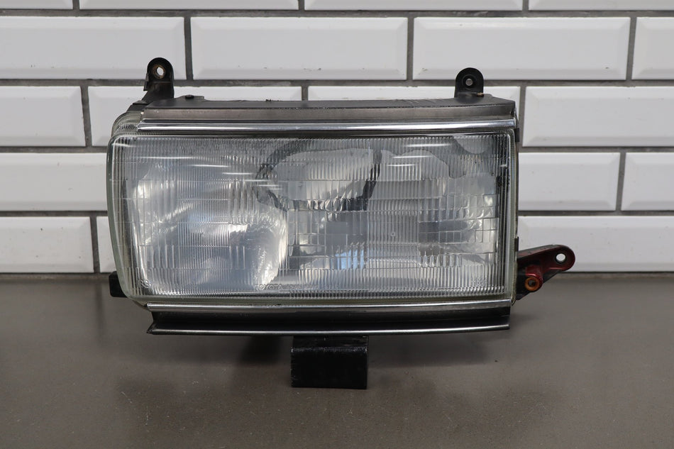 1991-1995 Toyota Land Cruiser Left Headlamp 8111060394
